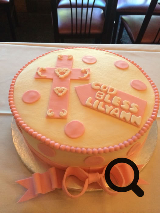 Charming dessert table setup featuring personalized cake pops and a tiered cake, perfect for celebrations.