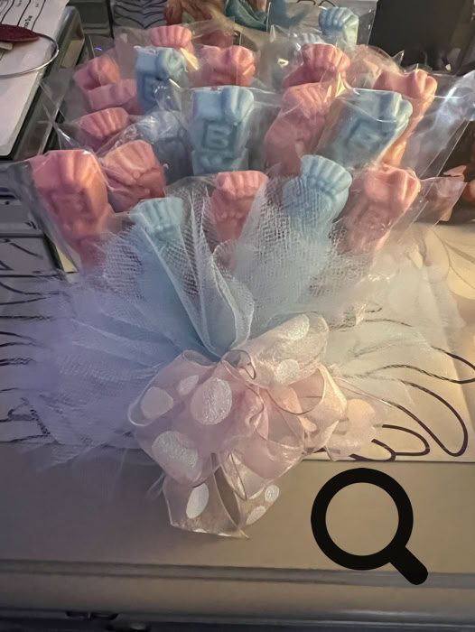 Charming dessert table setup featuring personalized cake pops and a tiered cake, perfect for celebrations.