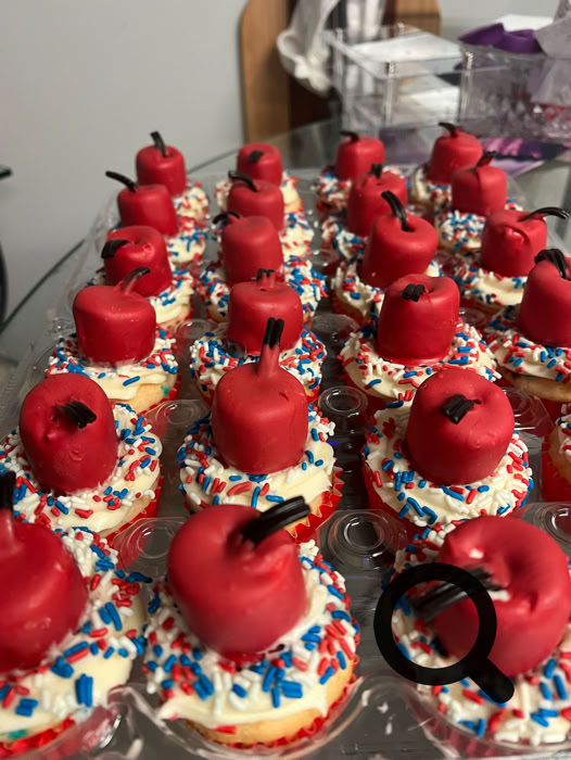 Charming dessert table setup featuring personalized cake pops and a tiered cake, perfect for celebrations.